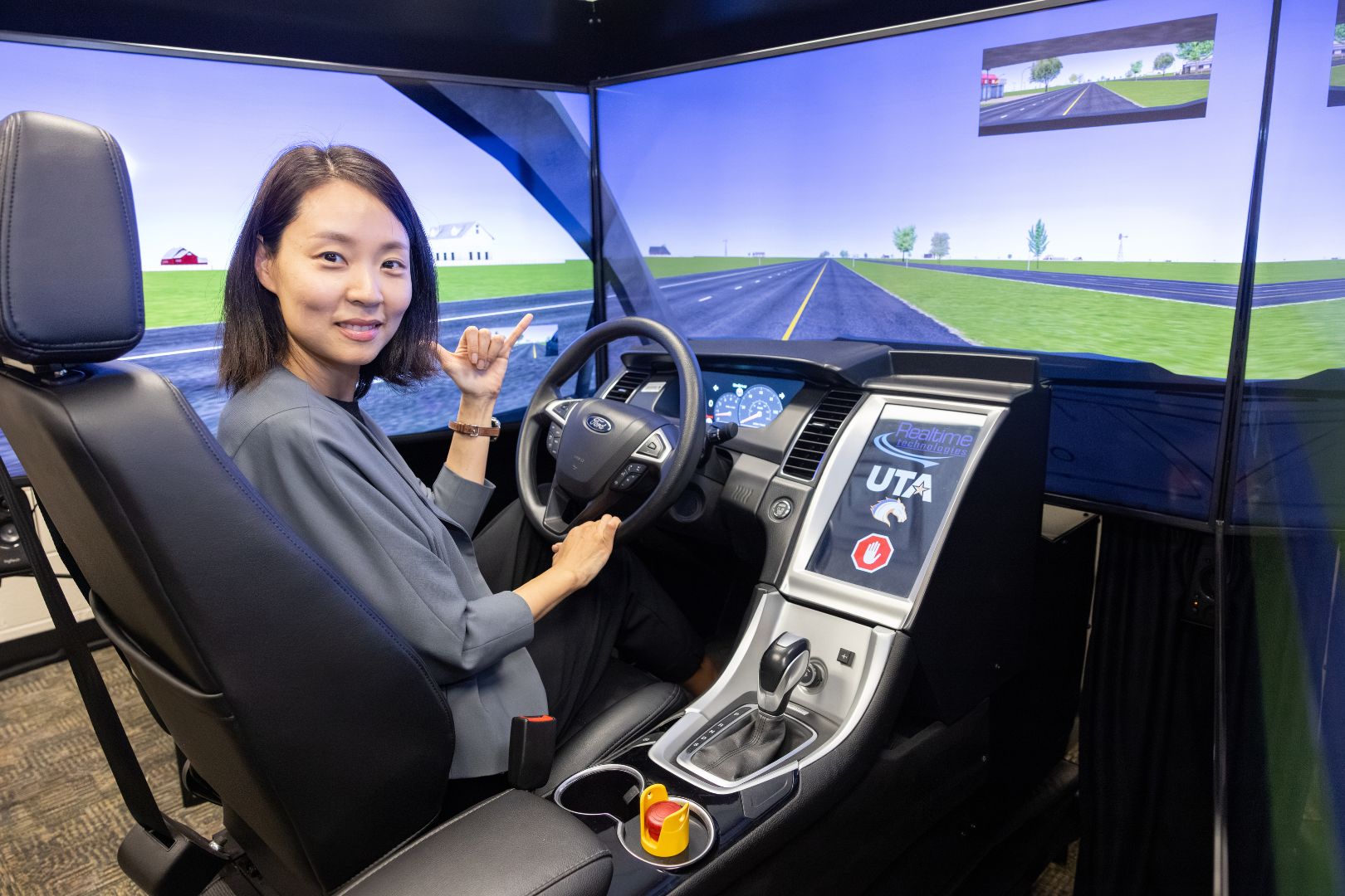 Image shows Dr. Kate Hyun in her driving simulator 