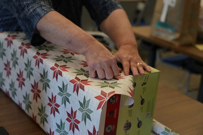 A UTA School of Social Work wraps an Angel Tree gift. (Photo by Jaelon Jackson)