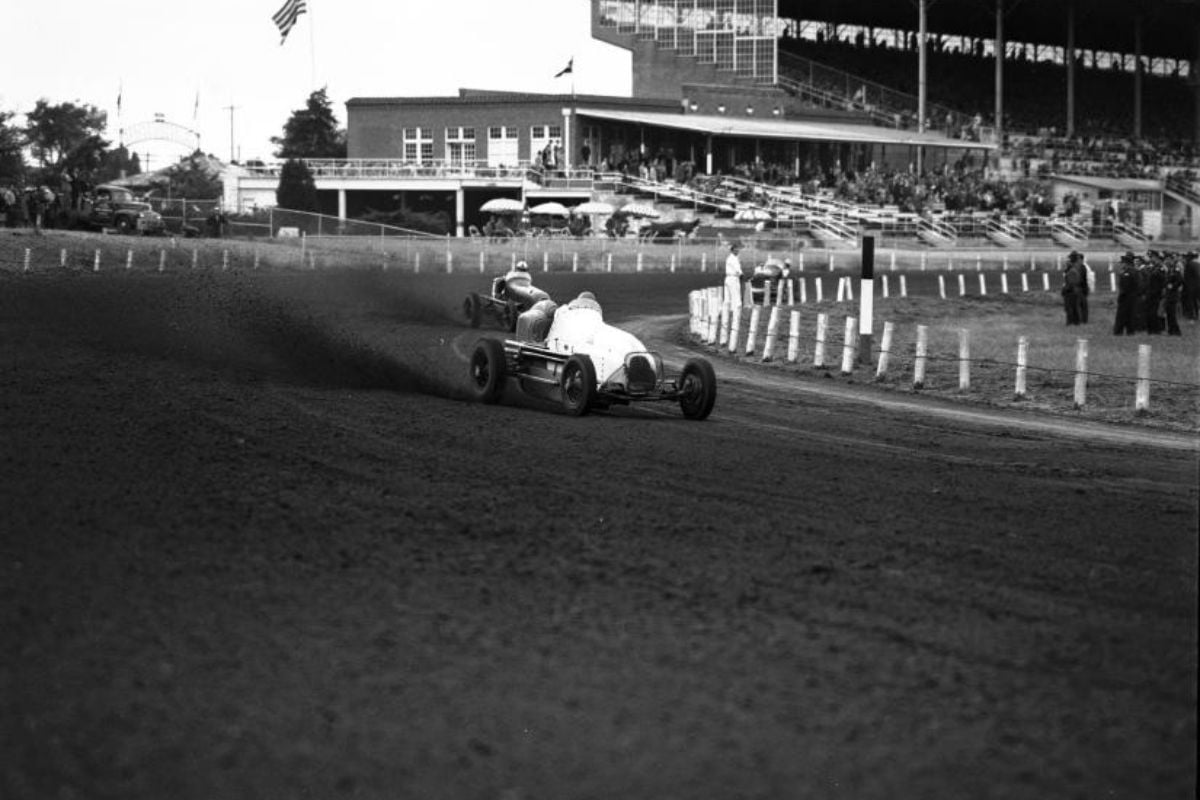 Driver Ted Horn as he skidding around the first turn in race at Arlington Downs with Duke Nalon following closely behind
