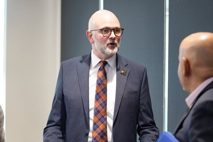 Dr. Kirk Foster, Dean of the UTA School of Social Work, speaks with Raul Gonzales, Deputy Mayor Pro Tempore and represents District 2 on the Arlington City Council, during a Deans Advisory Council Meeting. (Photo by Jaelon Jackson)
