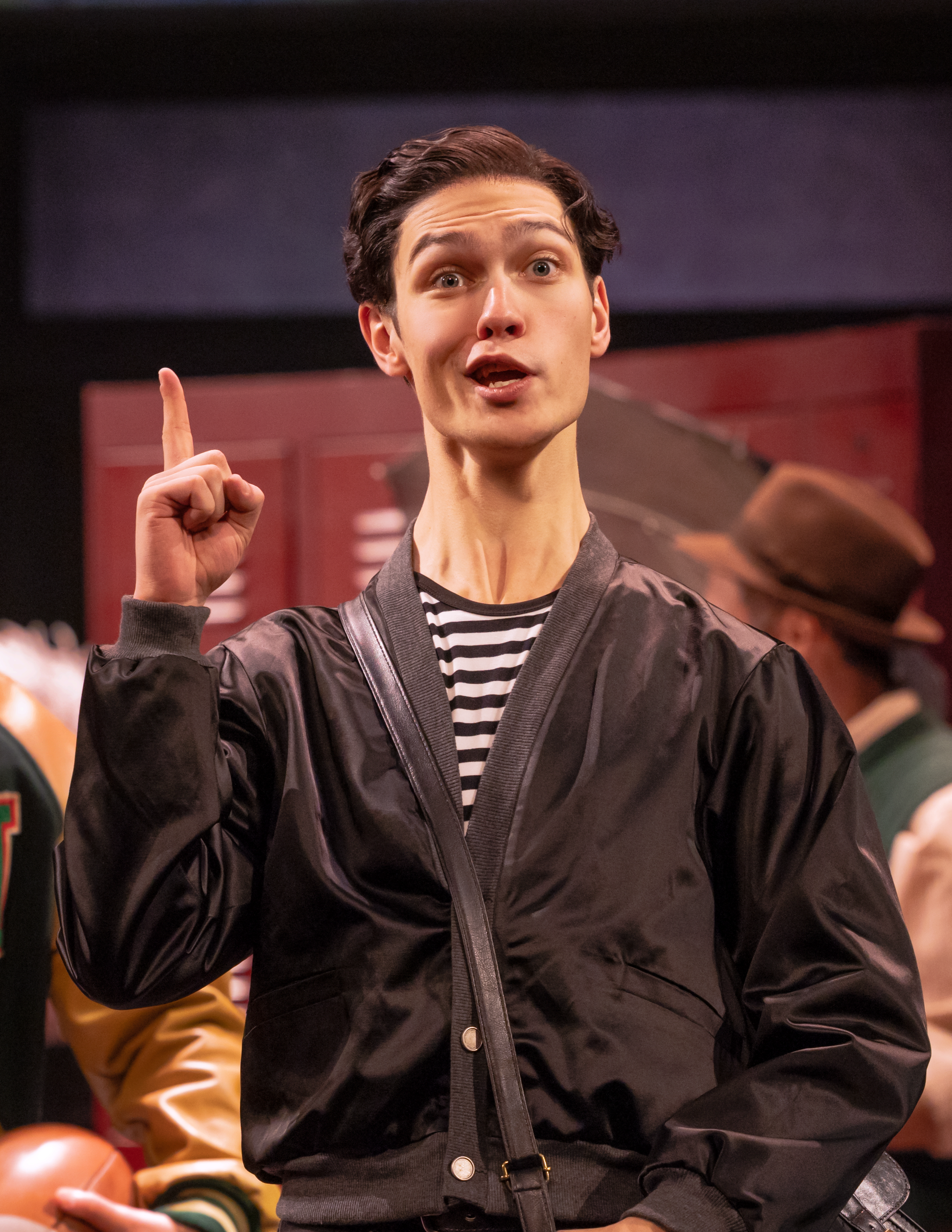 Close up of Ben Ashcraft playing Alan Munso in Stranger Things: First Shadow on Broadway, wearing a cross body bag.