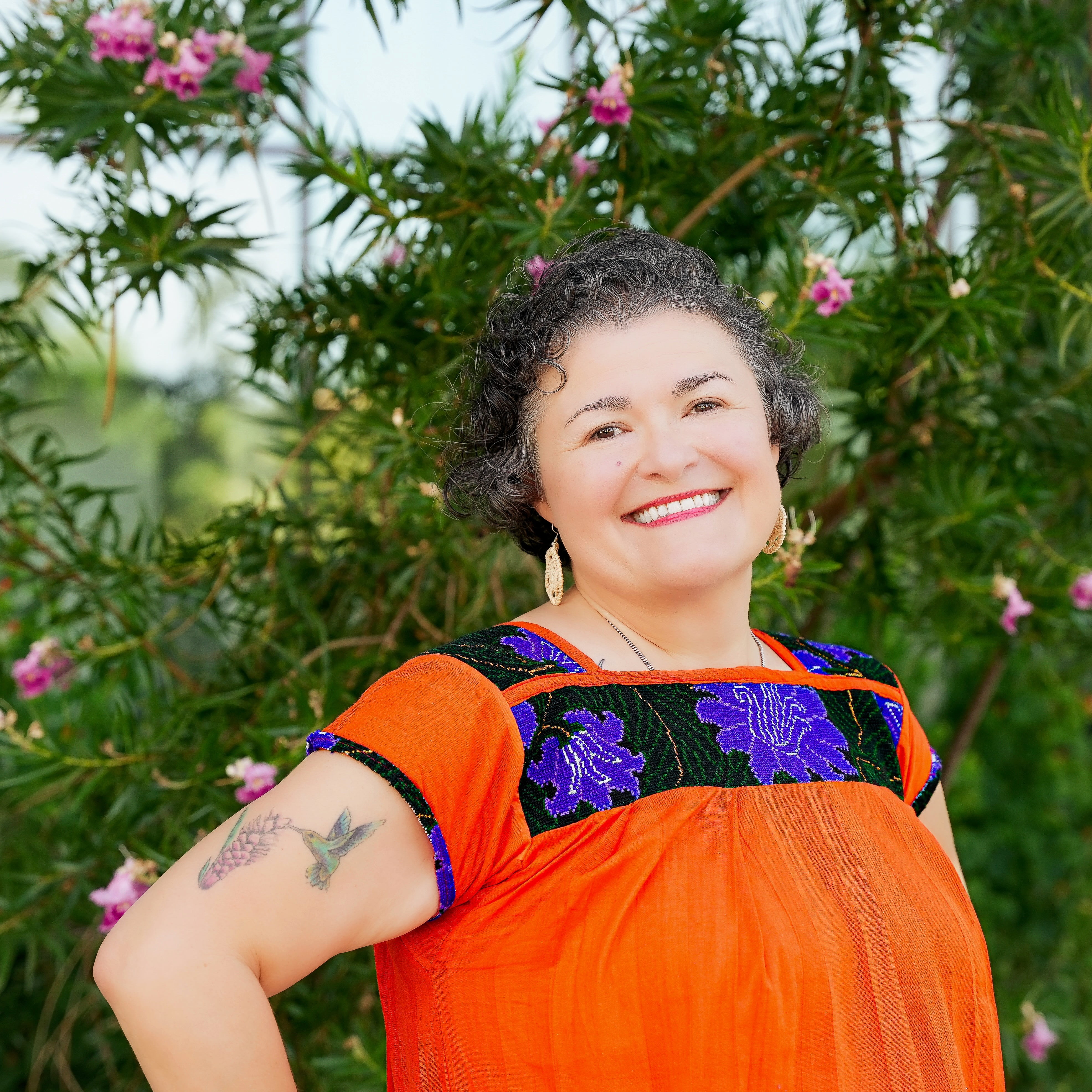 Dr. Regina T. Praetorius, Professor at the UTA School of Social Work, poses for a photo in an orange and blue shirt.