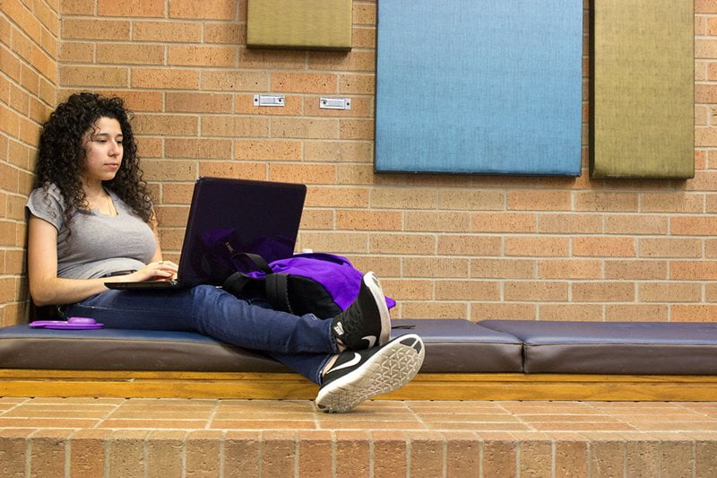 student studying laptop inside