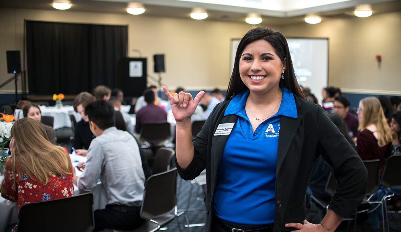UTA staff doing maverick hand sign