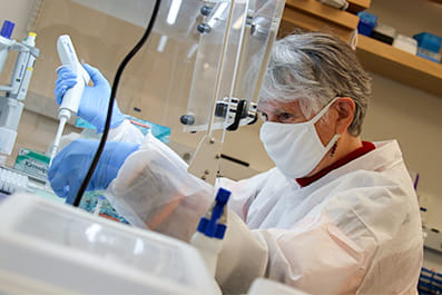 woman working in uta genome center