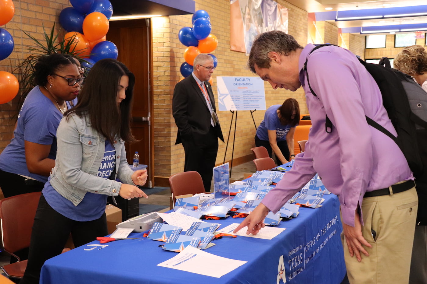 CRTLE staff assisting UTA faculty during an event 