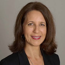 picture of Laura Phipps, dressed in a blazer and delicate necklace in front of a neutral background