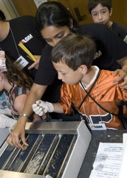 student examining something at an event