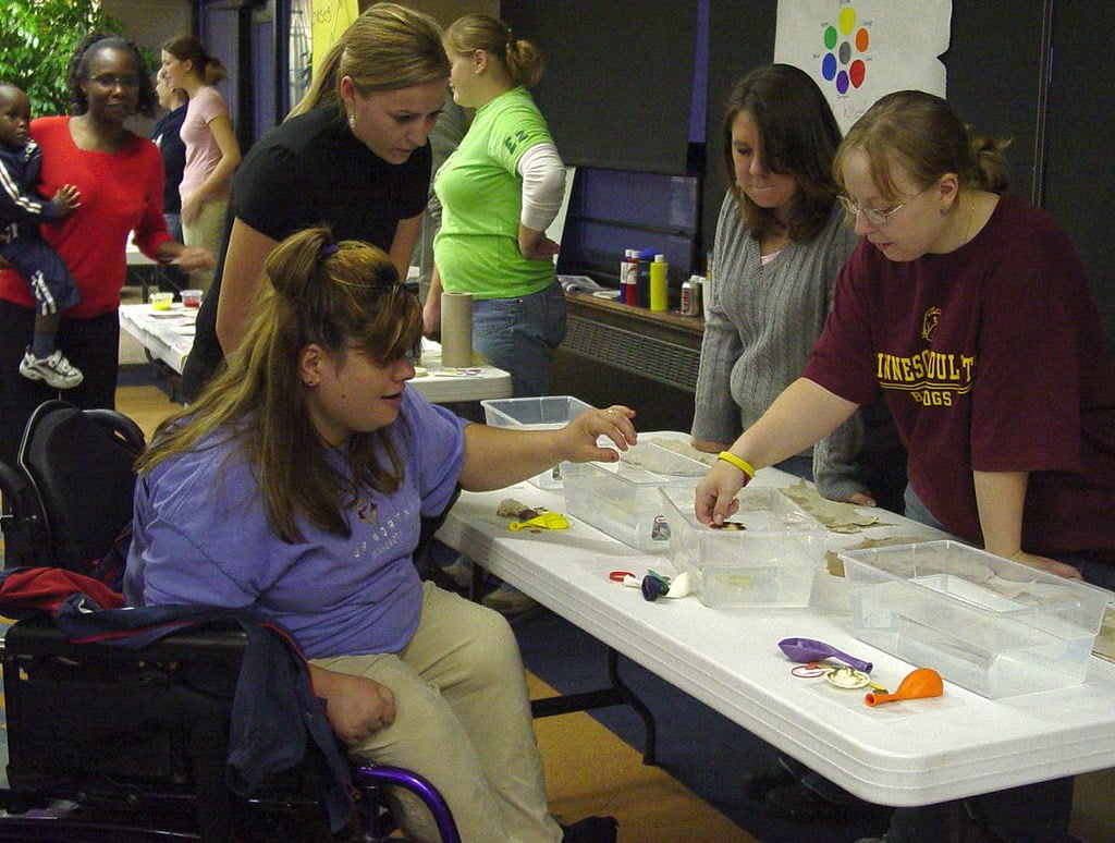 students with containers of water for a service learning science course