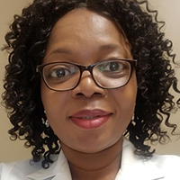 headshot of Agnes Titilayo Deleawe wearing glasses and a polo shirt