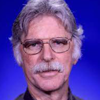 headshot of Dr. Thomas A Dombrowsky wearing glasses and a dark shirt