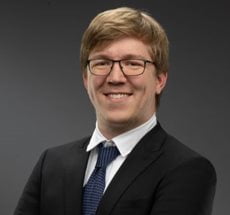 professional headshot of a man in jacket and tie