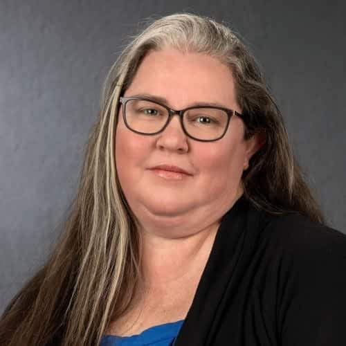 woman  in glasses with a slight smile