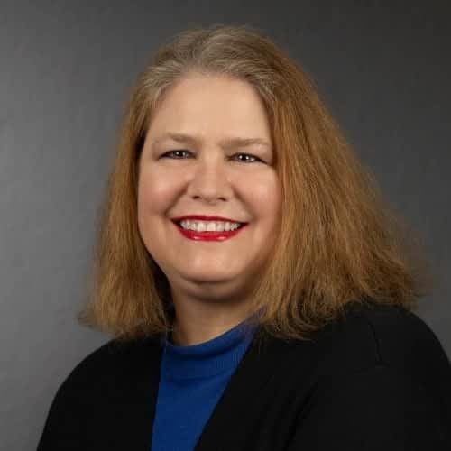 smiling woman with shoulder-length red hair