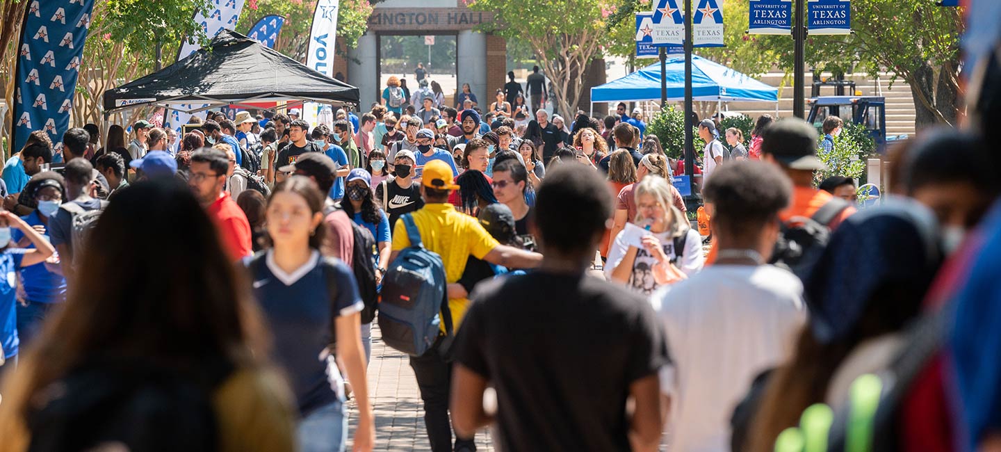 Students walking in front of the University Center during Maverick Activity Fair Day.