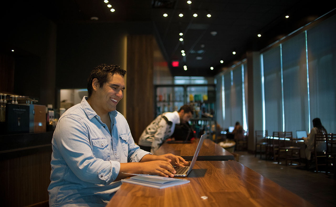 student laptop inside smiling