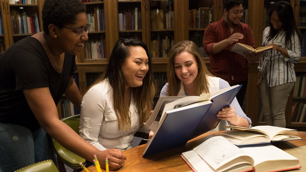 Students studying a book together