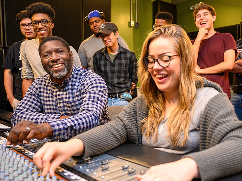 Students learning in music lab.