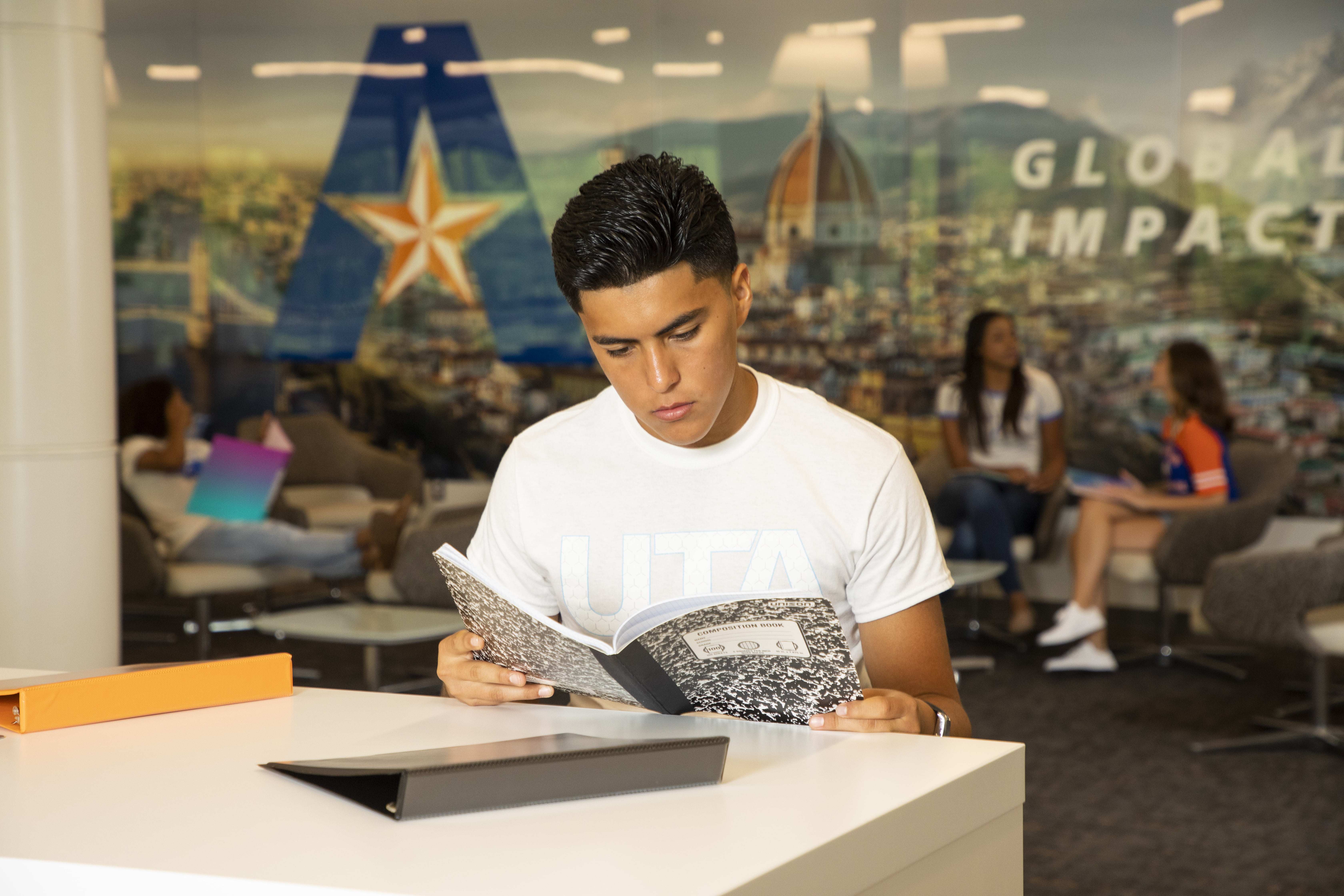 Student reading a book on campus