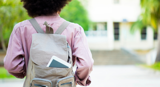 student with backpack from behind