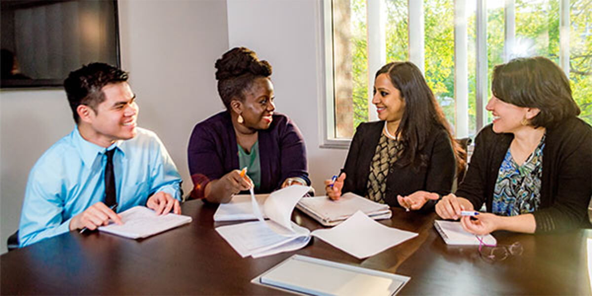 4 students talking and laughing at each other