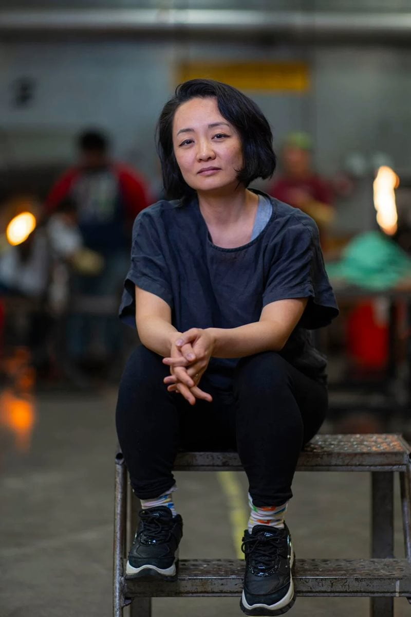Gyun Hur sitting on a chair