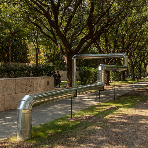 A exhibit of a metal pipe at an art exhibit 