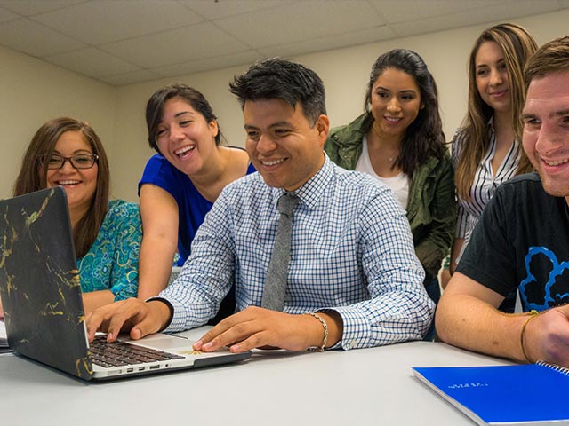 Students around a laptop