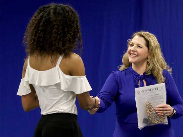 Two women shaking hands