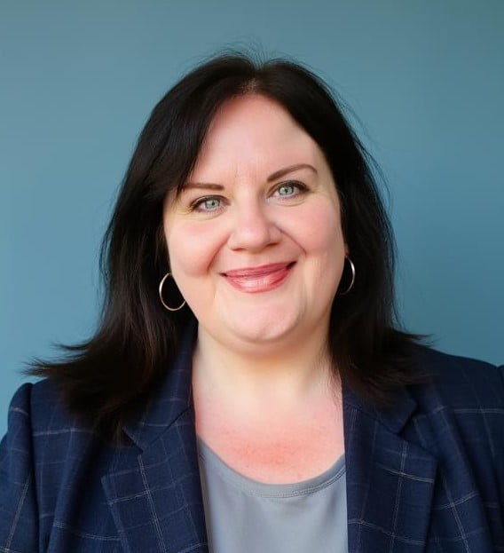Jennifer LaPrade smiling with short hair, a blazer, and a simple shirt.