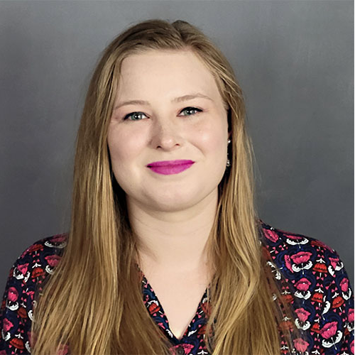 Lainie Allen smiling with long straight hair wearing a patterned blouse