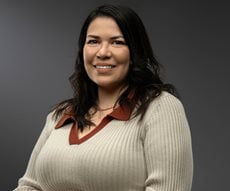 Mikila Salazar smiling with medium-length hair and a long-sleeve shirt