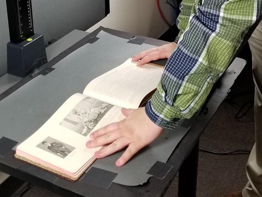 Student positioning book for picture