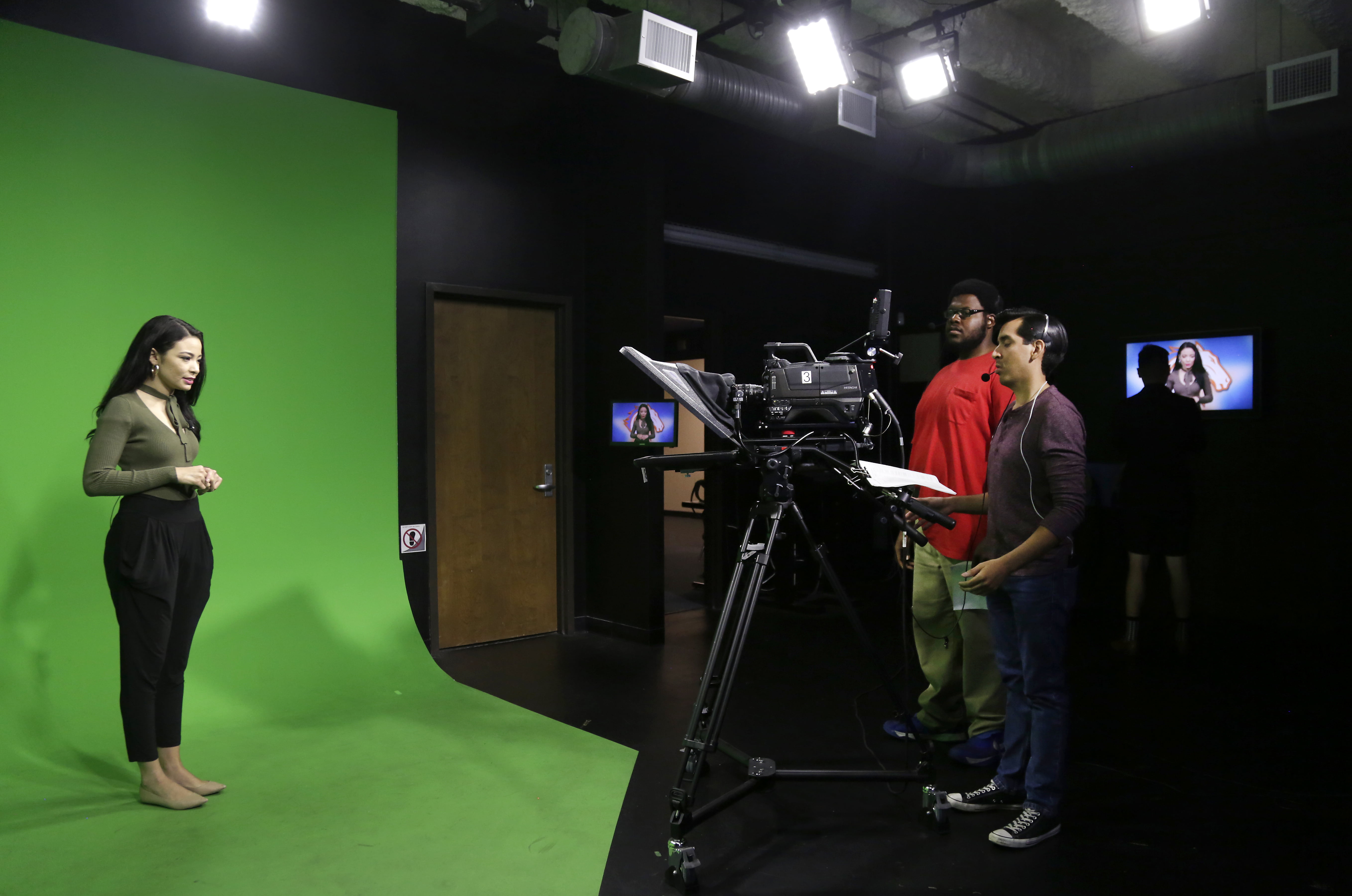 Woman in front of green screen