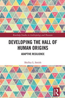 Developing the Hall of Human Origins book cover with a multi-color triangle-pattern and the title in the middle over a solid color rectangle