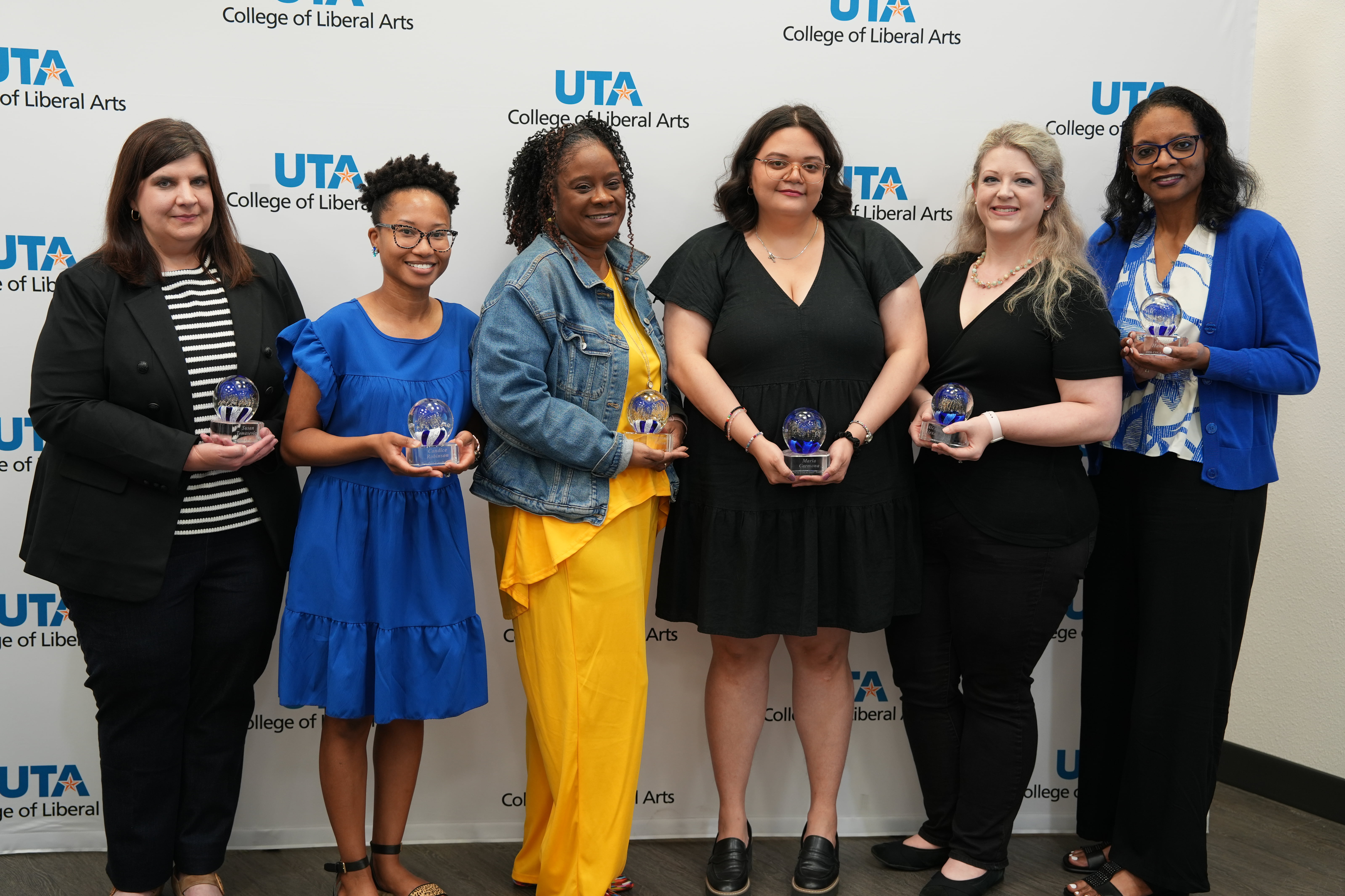 Six staff holding their awards