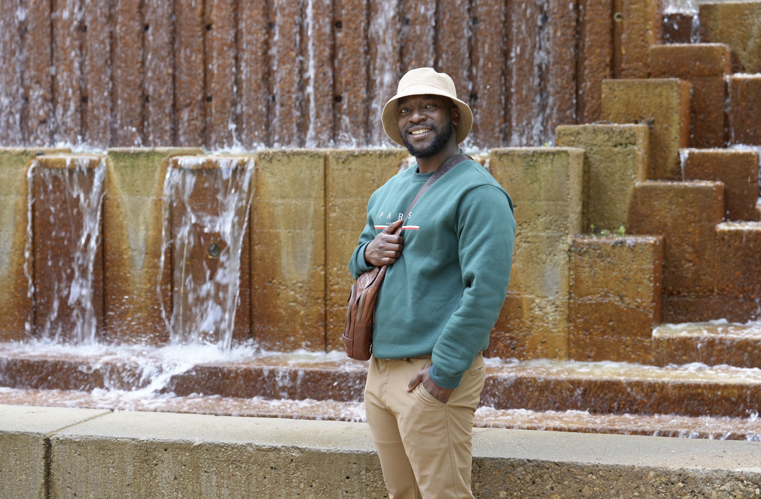 Gabriel standing in front of the Fine Arts water fountain.