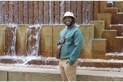 Gabriel standing in front of the Fine Arts water fountain.