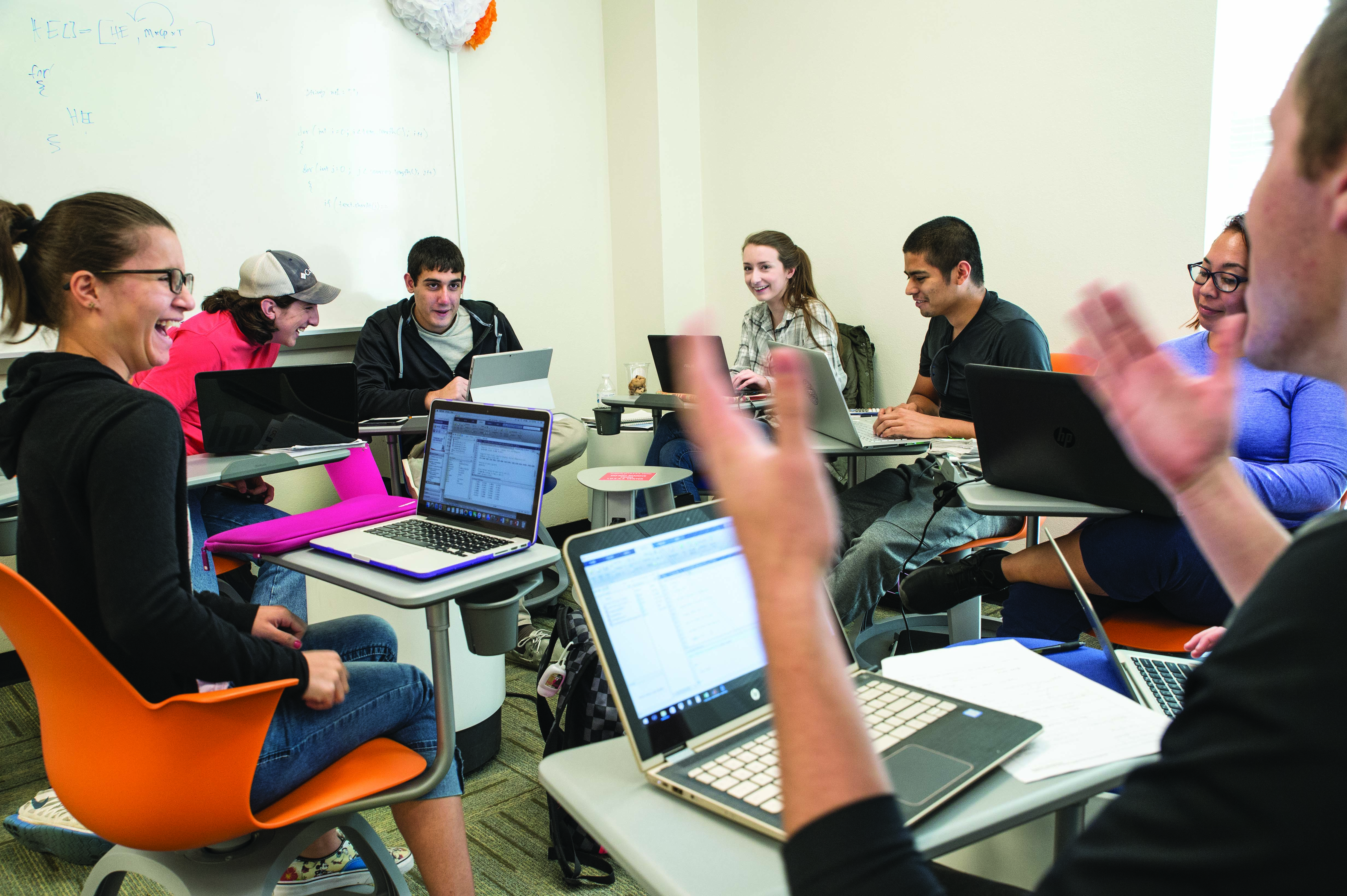 students engaged in a conversation, seated in a circle