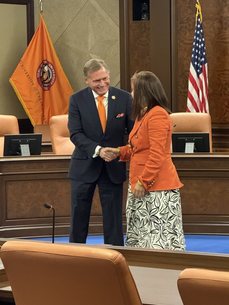 Dr. Peggy Semingson exchanging a handshake with another person.