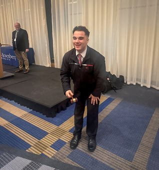 Jose Sparling posing with a gavel.
