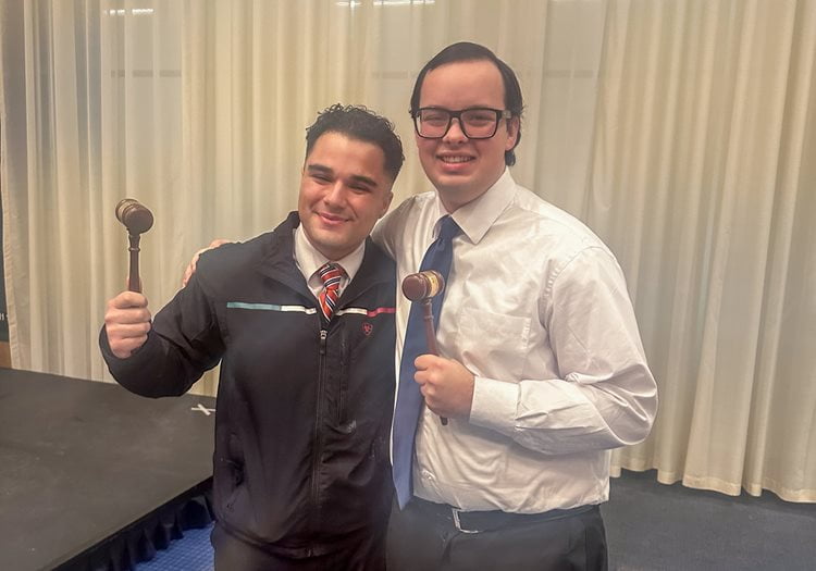 Jose Sparling and Timothy Flach smiling and holding up gavels.