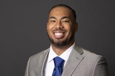 Jayce Smith headshot. He's smiling and wearing a suit.