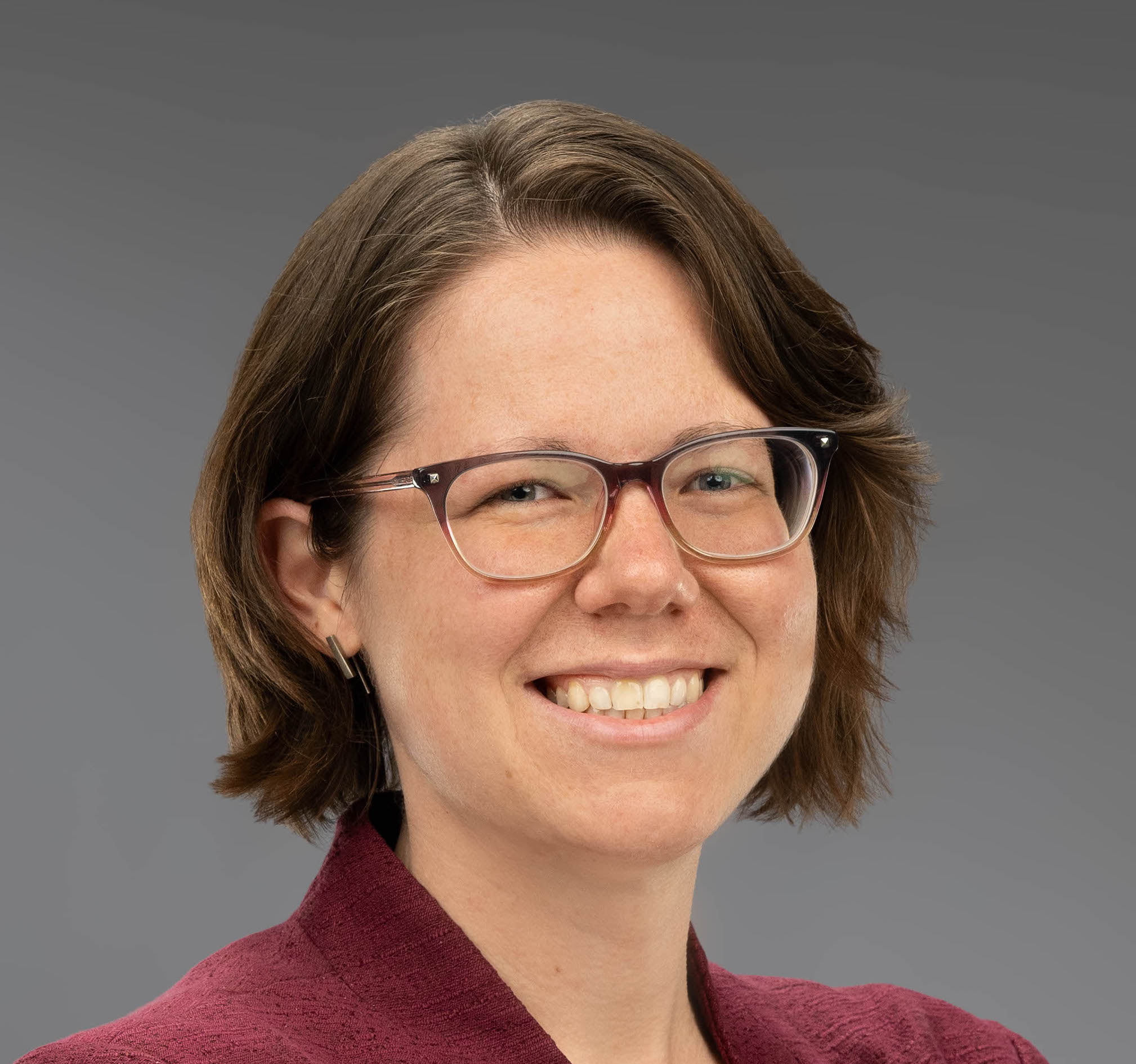 head shot of Dr. Ivy Hauswer in a red shirt