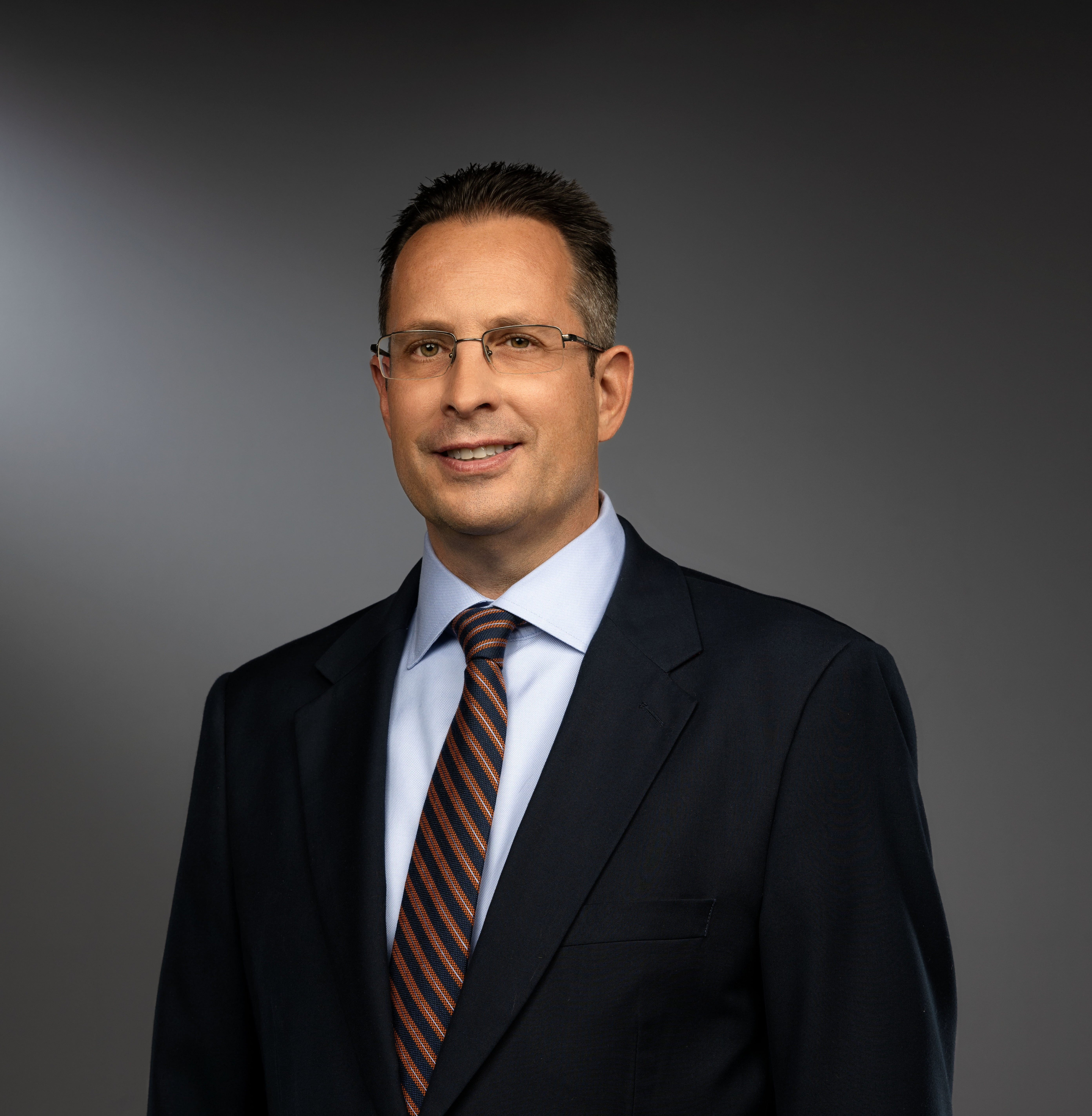 Photo of a man in a suit and tie