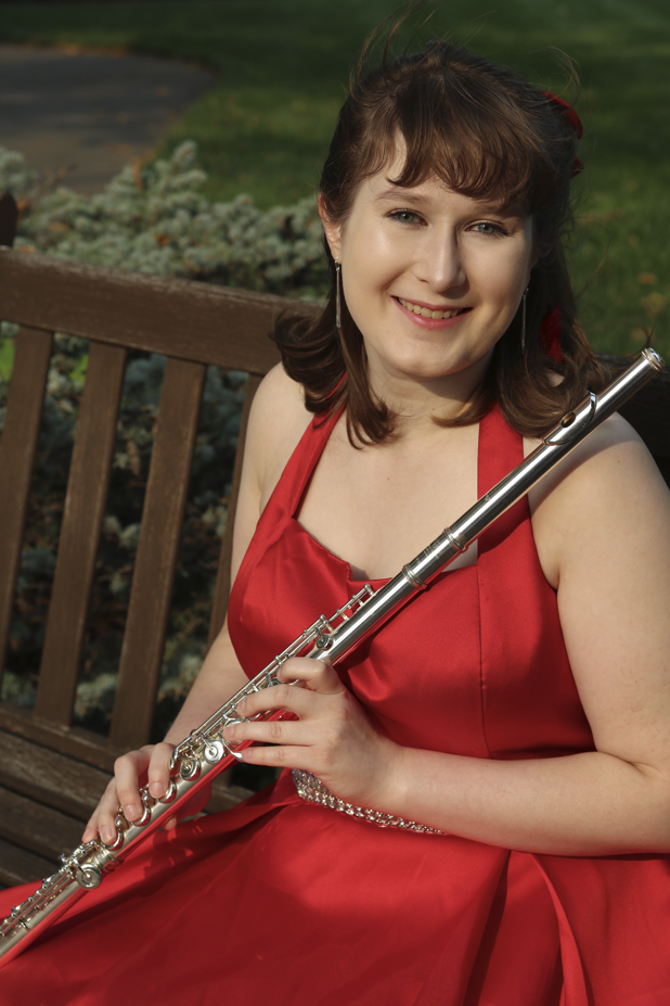 Alison Parker sitting on a bench wearing a dress and holding a flute.