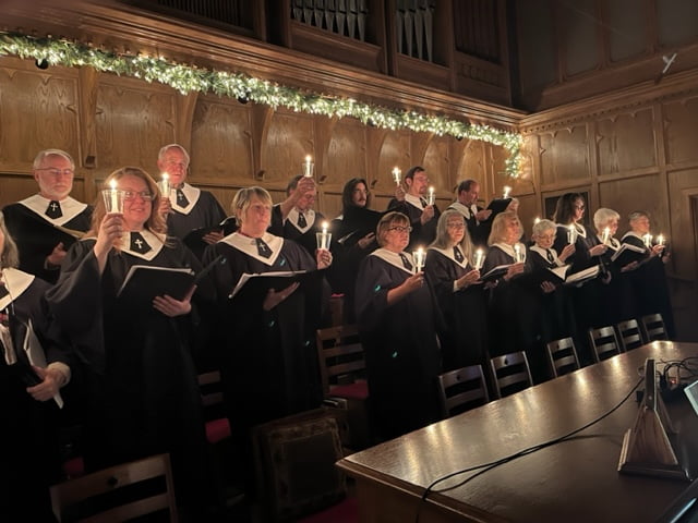 Church choir singing and holding candles