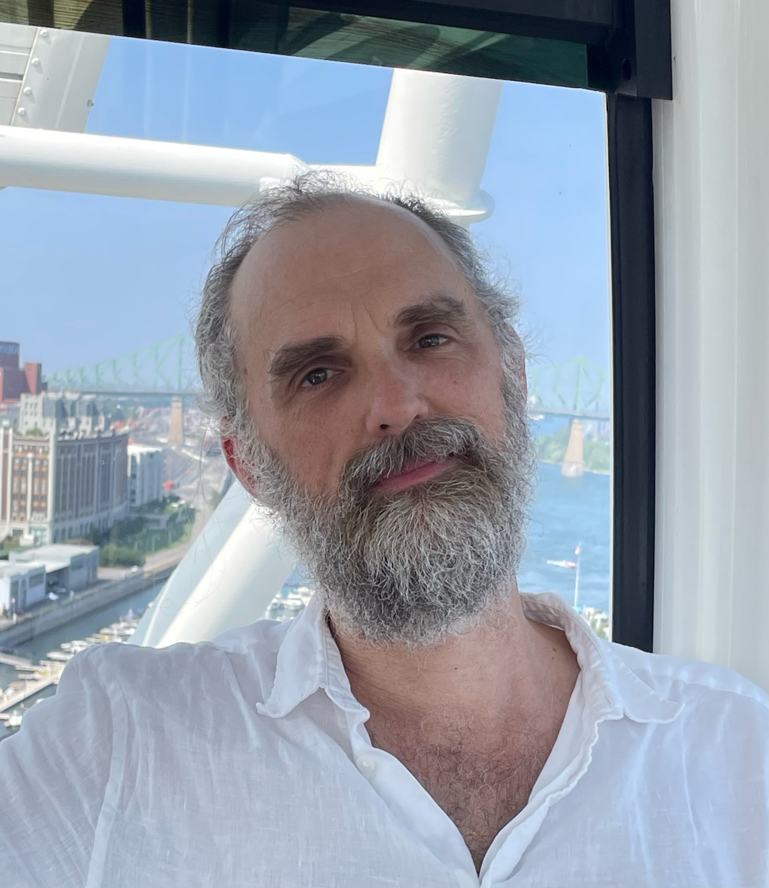 Kenneth Williford in a button down shirt in front of a window