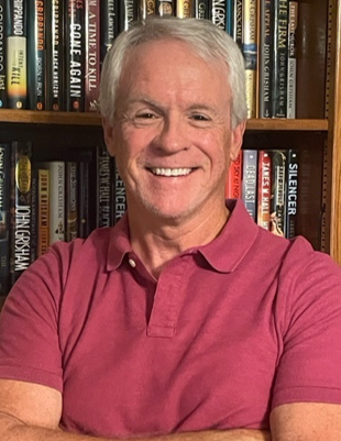 Dr. Farris in front of book shelf