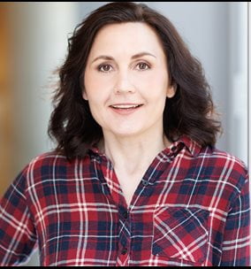 Alice Nelson headshot with shoulder length dark brown hair and red and blue plaid shirt.
